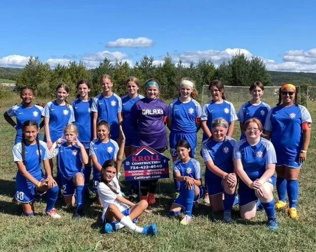 A team photo of a youth girls soccer team.