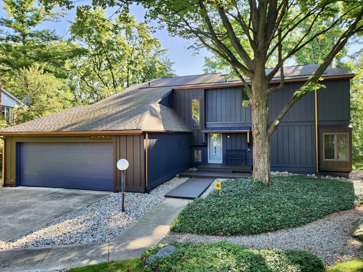 A home with black shingles recently installed as a roof replacement.