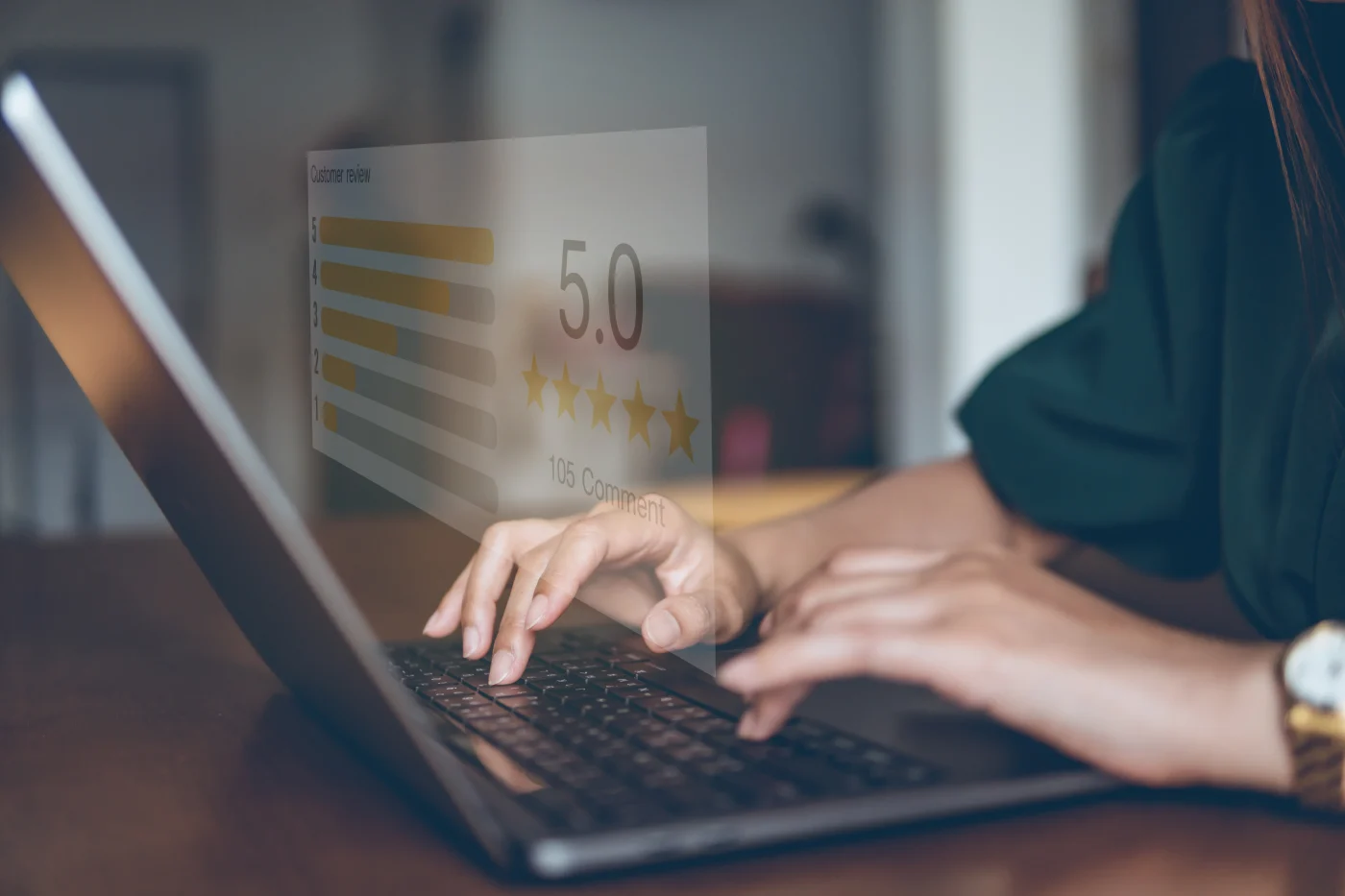 A person leaving a 5-star review on a laptop.