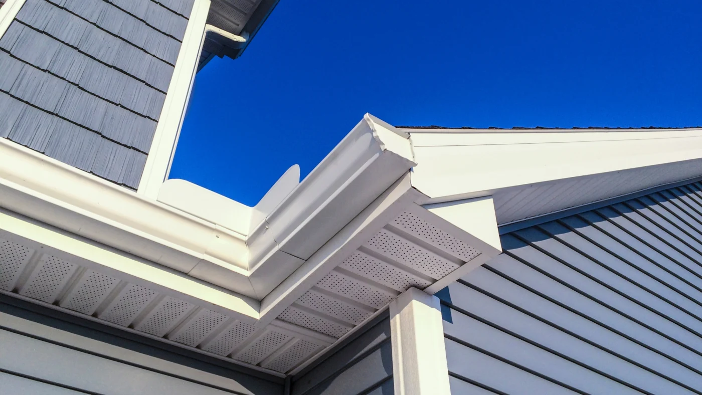 The corner of a home zoomed on the gutter joint.