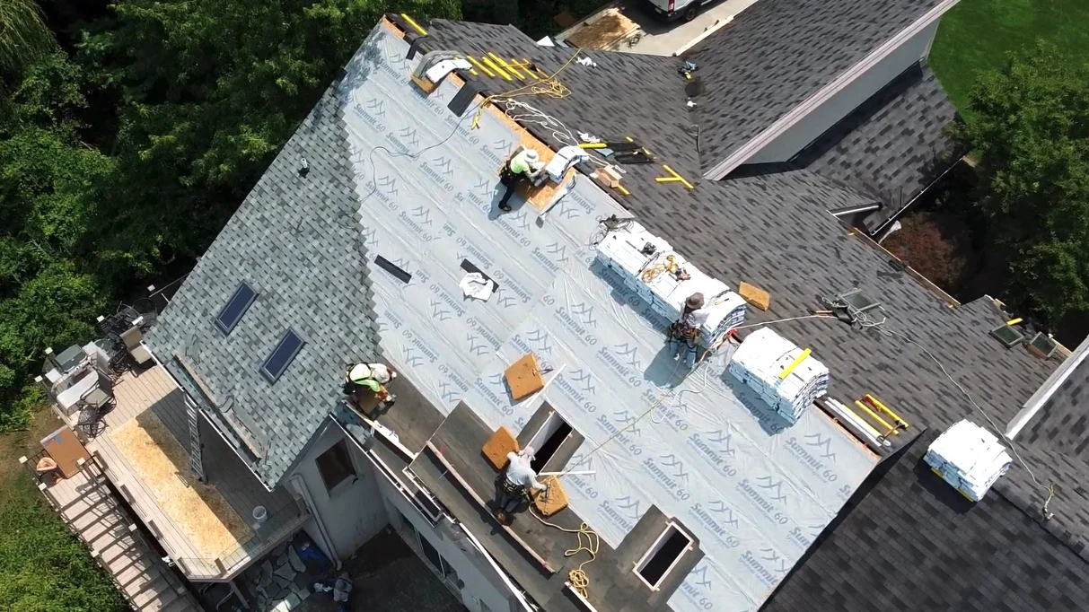 A Kroll Construction team installing a shingle roof