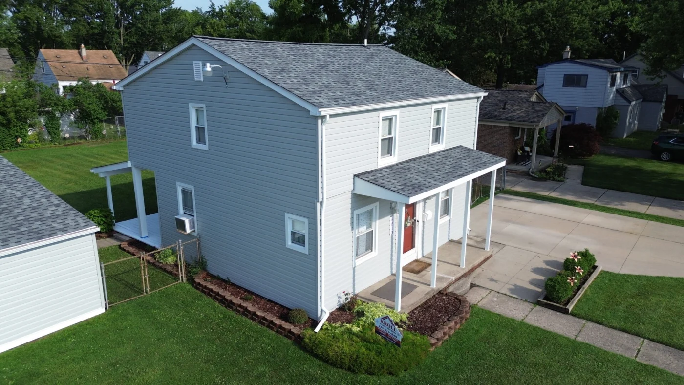 Gray roof and new siding on house after suffering storm damage