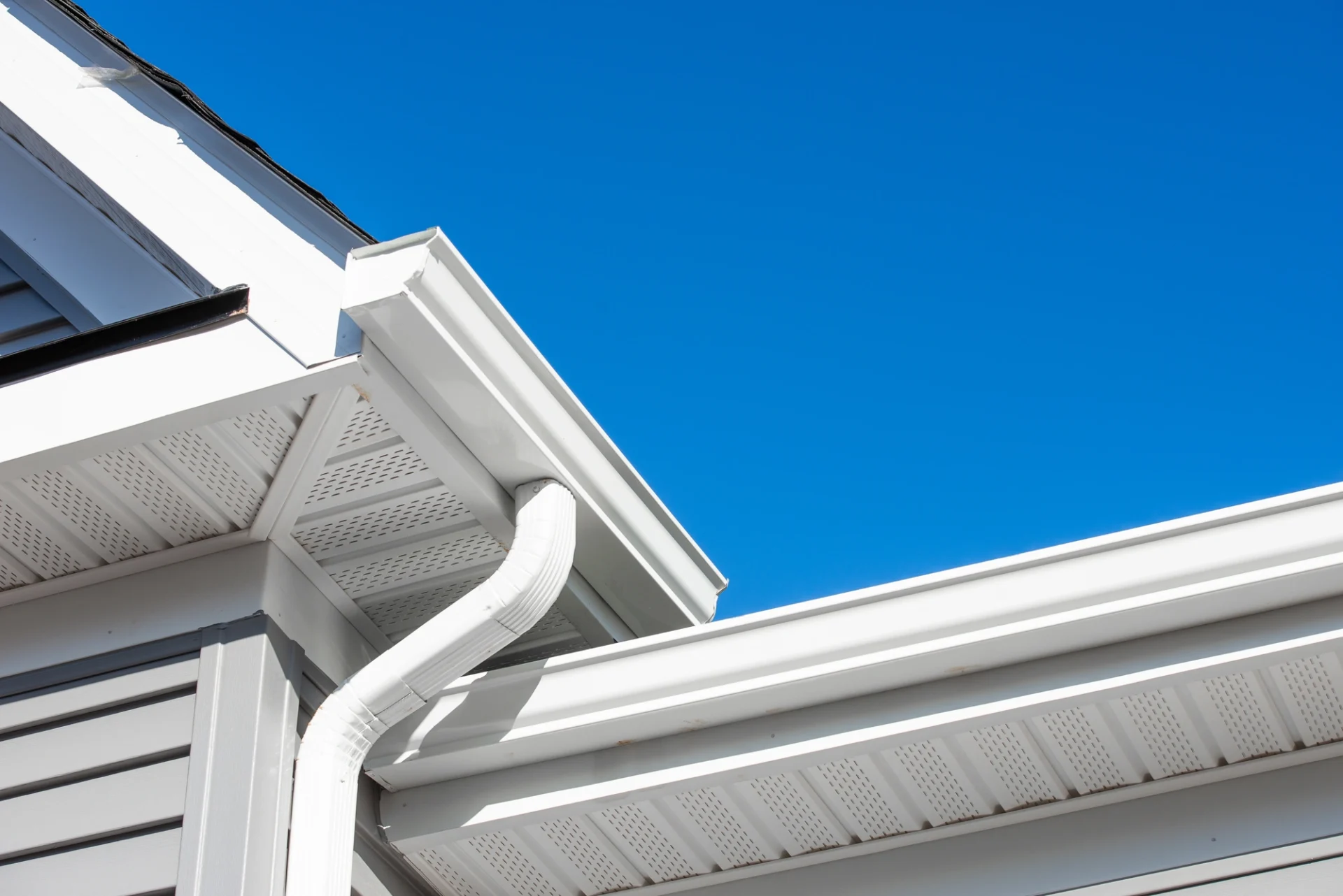 There are white gutters on the home