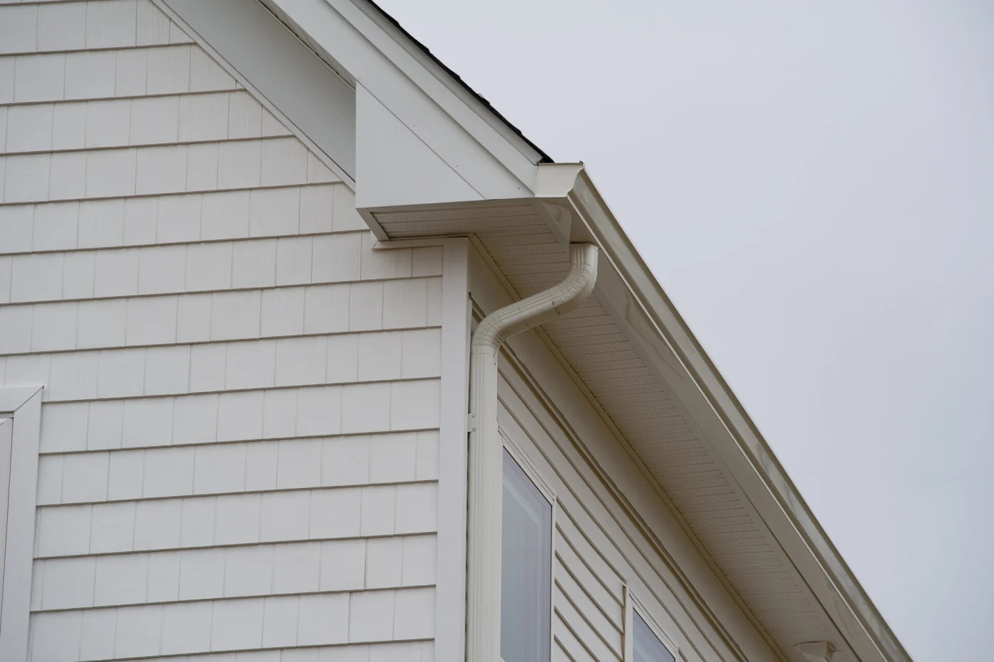 There are white gutters on a white home