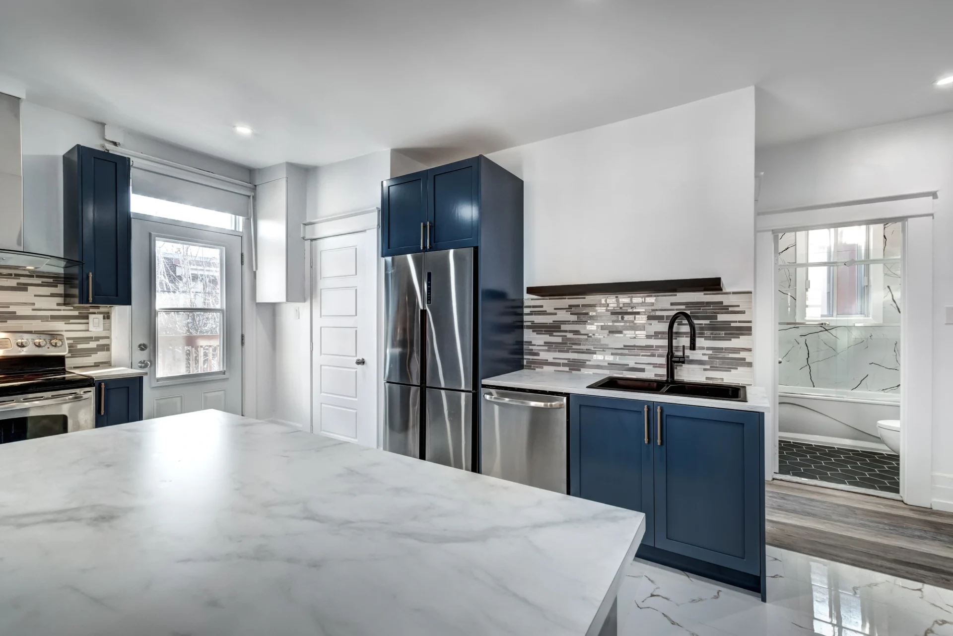 Beautiful Kitchen Remodel With Countertops, Stainless Appliances, And Blue Cabinets