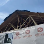 Wide view of the damaged side of Dalton and Sierra S.’s home