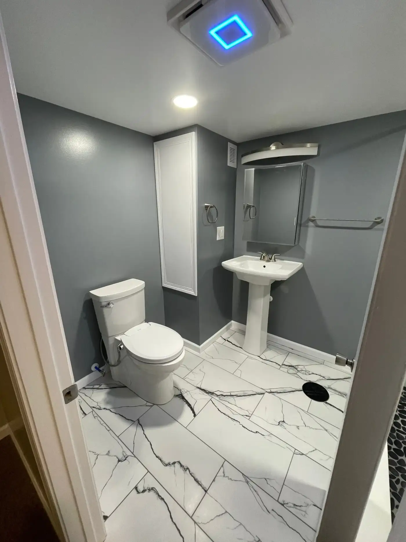 Sleek bathroom with quartz flooring and dark gray walls
