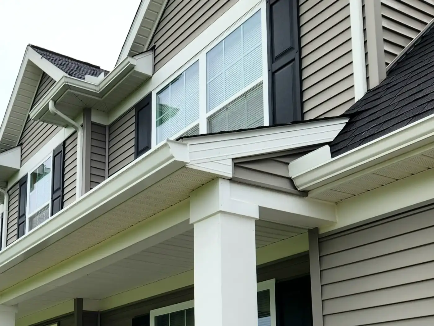 White seamless gutters on home
