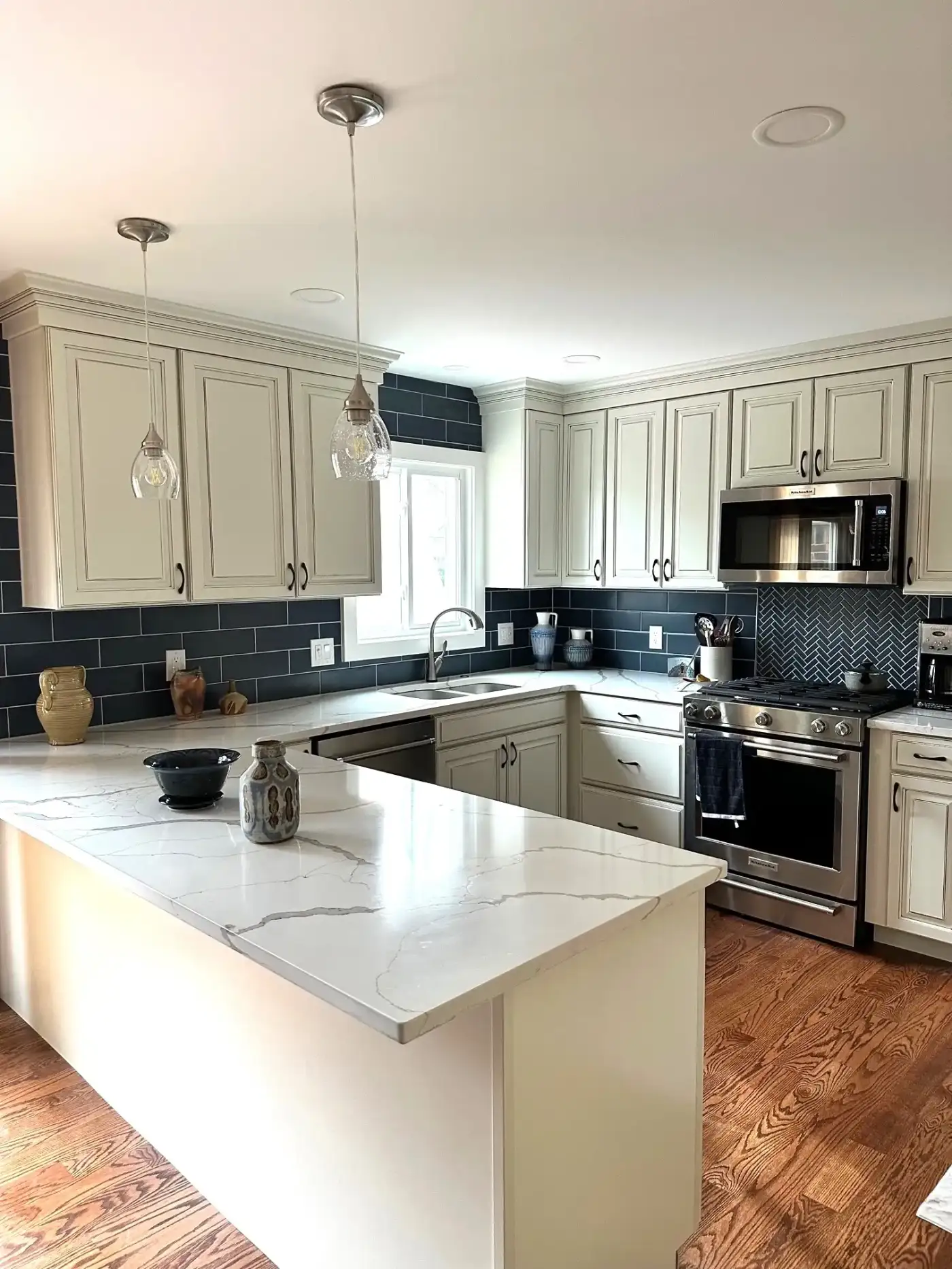 Remodeled kitchen with white countertops and cabinets