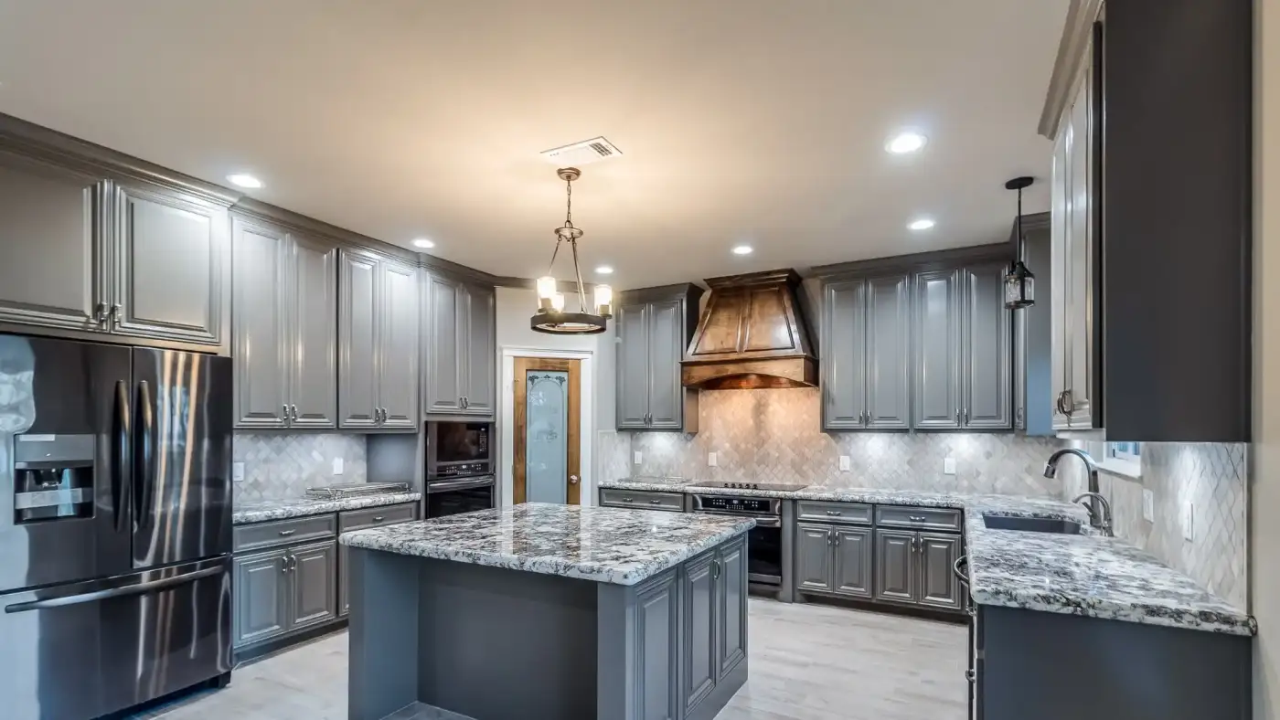 Spacious remodeled kitchen with granite countertops and gray cabinets