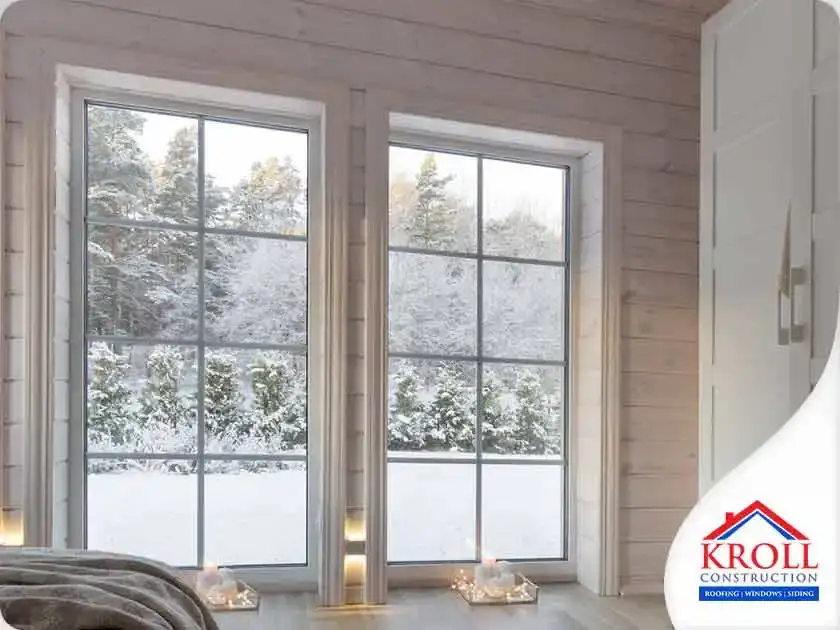 Large windows from inside a bedroom, overlooking winter landscape