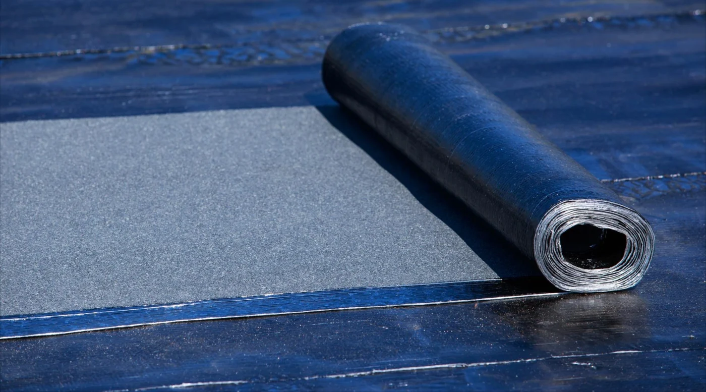 Up-close image of EPDM roofing in a roll on a roof
