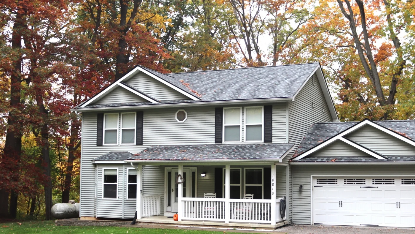 Image of a large two-story house with a garage and a grey shingle roof