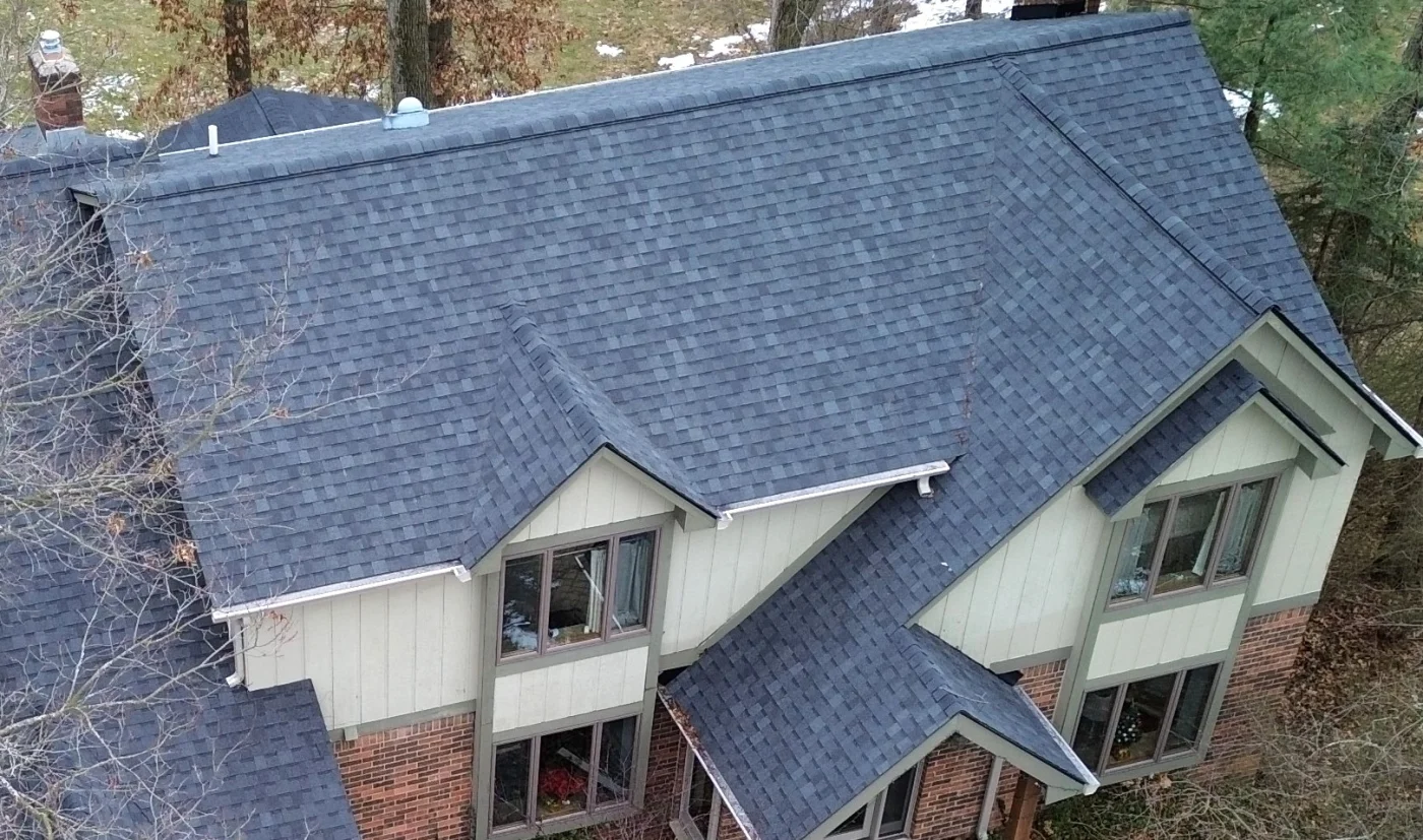 Far-off image of a black shingled apartment roof