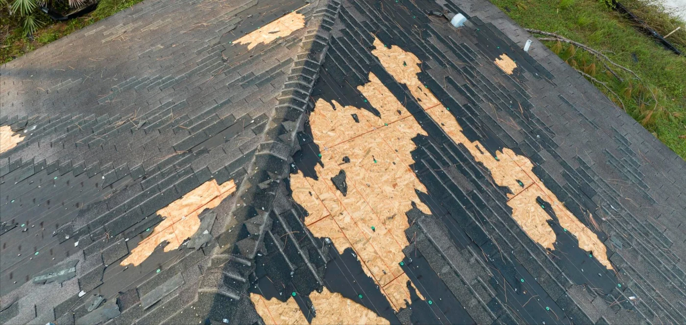 Image of a roof with shingles ripped off after a storm