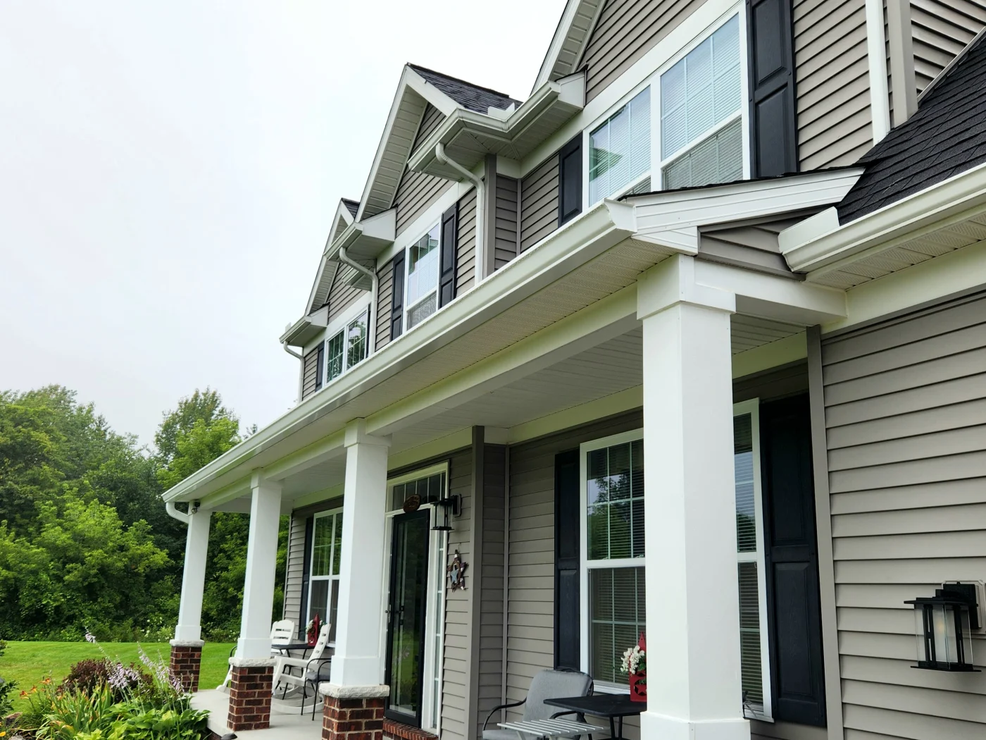 Angled view of home with white seamless gutters along front