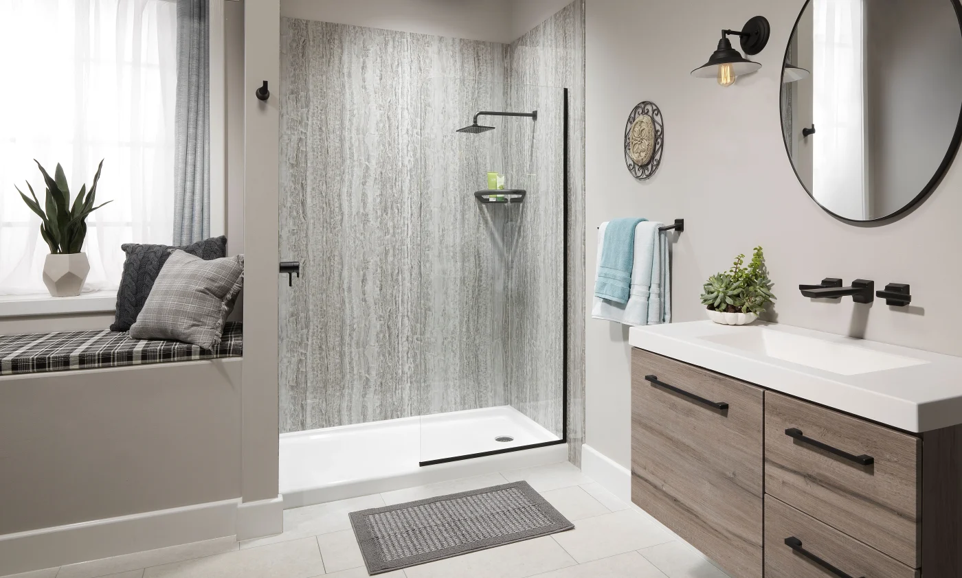 A newly installed Luxury Bath walk-in shower with a white base and gray surrounds
