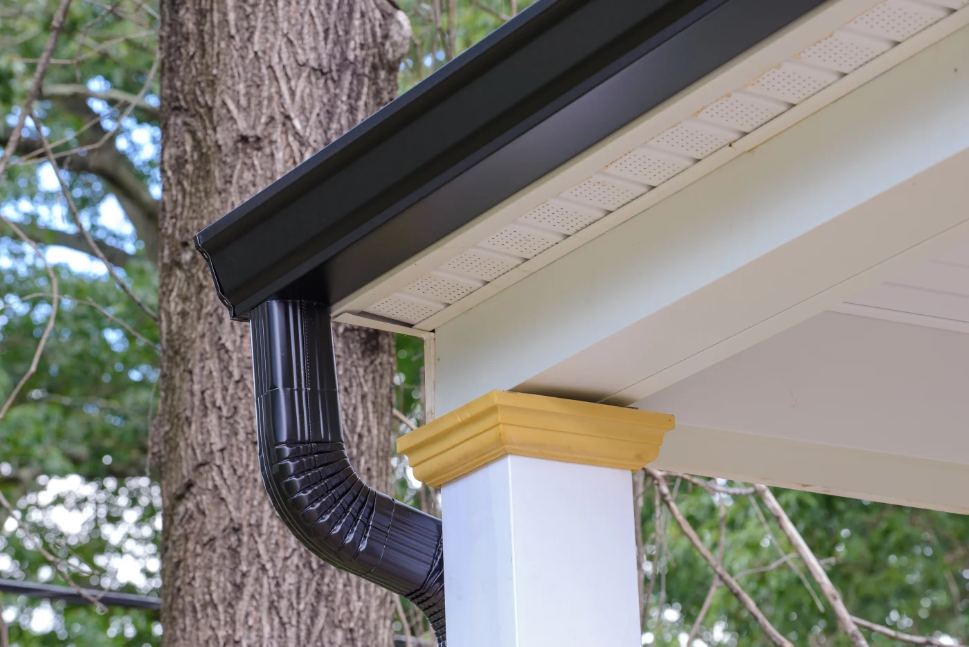 A close-up view of black gutters installed on home.