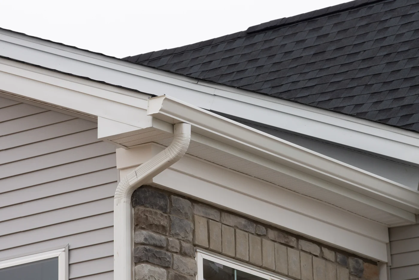 White seamless gutters installed on a suburban home