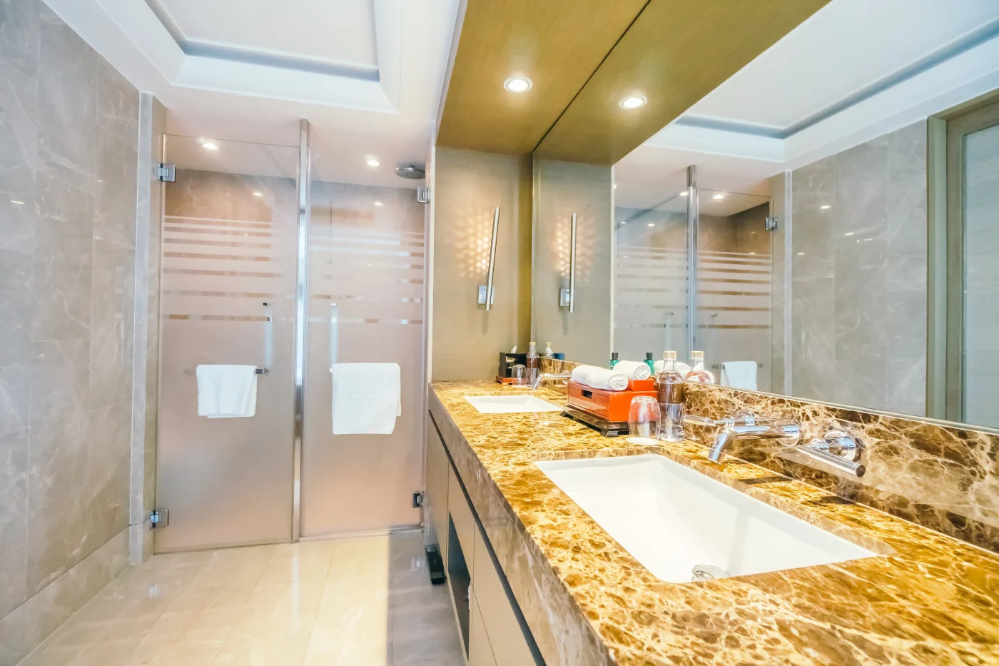 A walk-in shower with frosted glass doors installed in a bathroom.